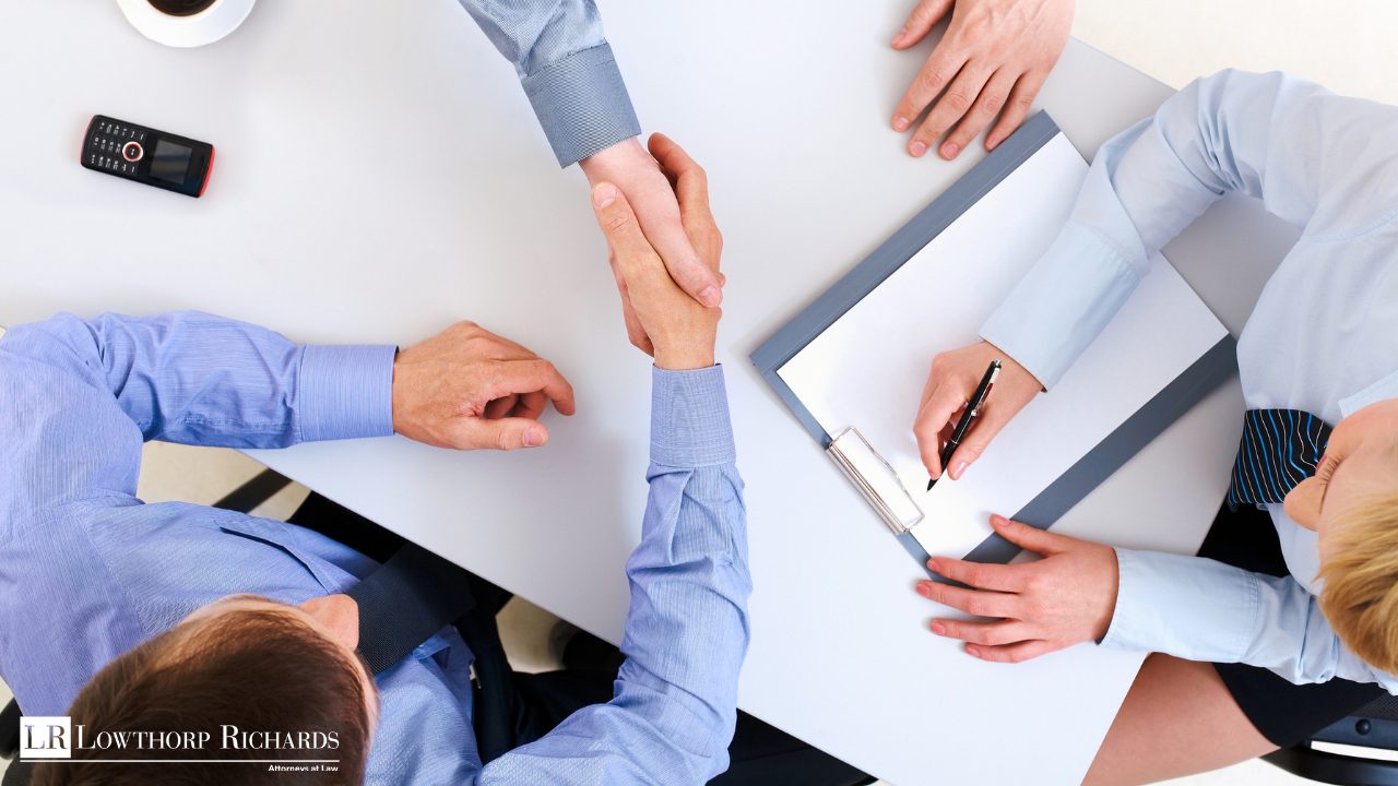 shareholders shaking hands over a buy-sell agreement